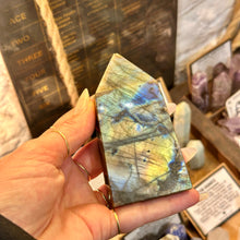 Load image into Gallery viewer, Labradorite obelisk turned in the hand to show its golden flash - Let's Jam, Camden Market London