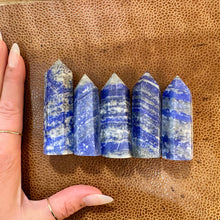 Load image into Gallery viewer, Lapis lazuli towers one to five next to a hand to show their size - Let's Jam, Camden Market, London