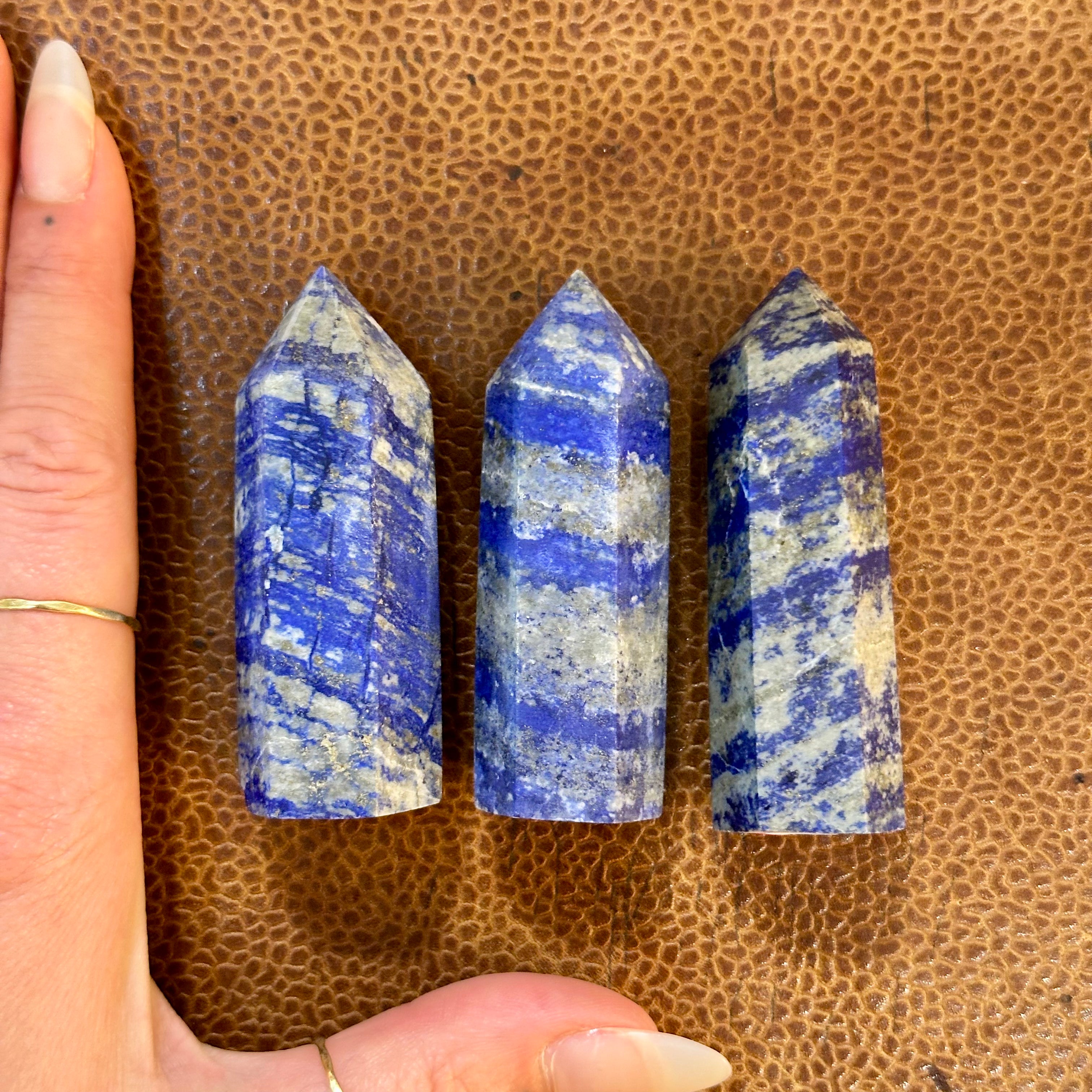 Lapis lazuli towers eleven to thirteen next to a hand to show their size - Let's Jam, Camden Town