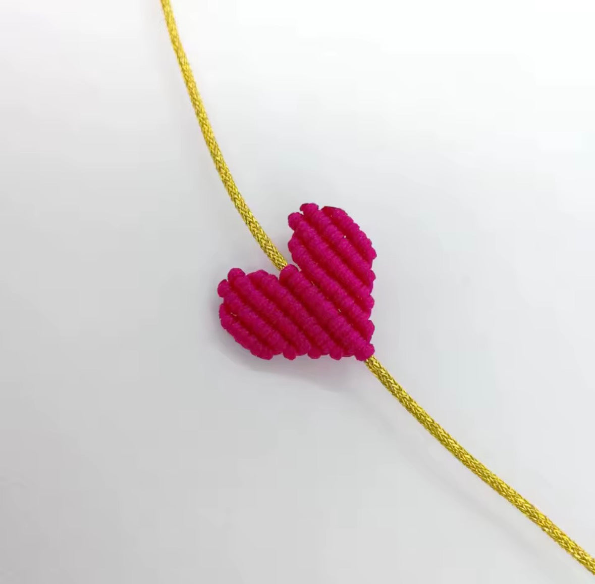 Fuchsia macramé heart bracelet on a gold cord - Let's Jam, Camden Market, London