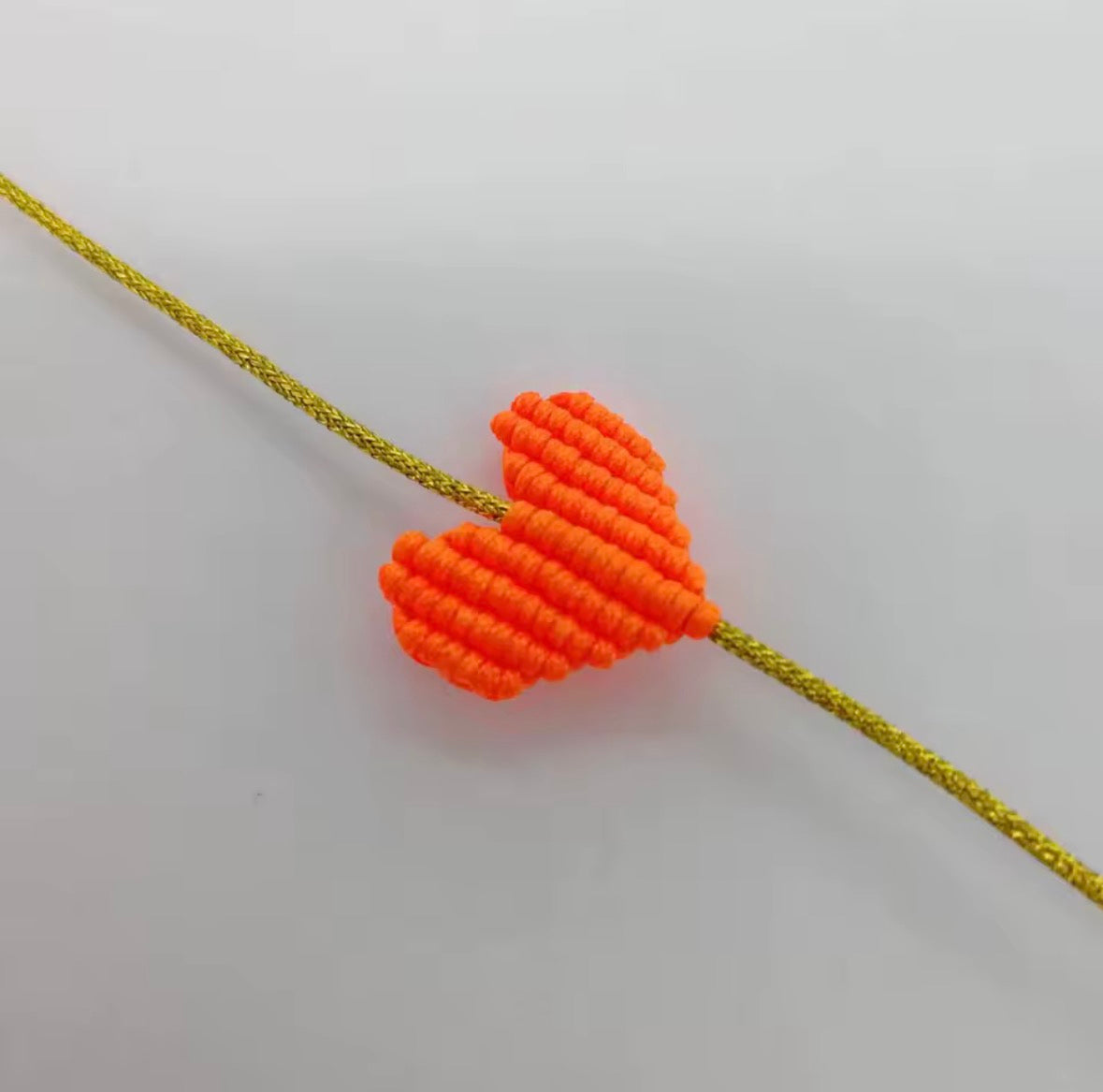 Neon orange macramé heart bracelet on a gold cord - Let's Jam, Camden Town London