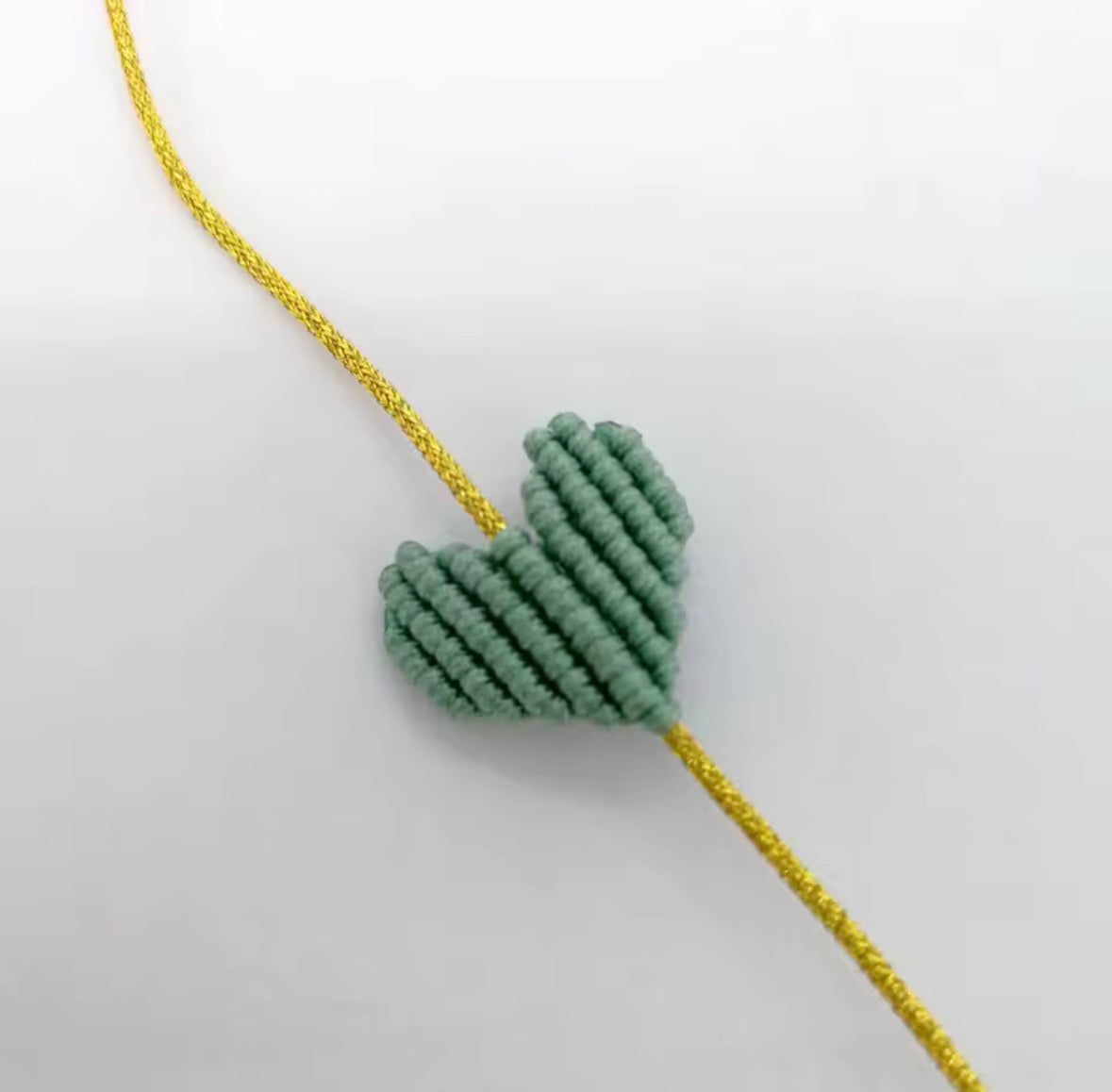 Sage green macramé heart bracelet on a gold cord - Let's Jam, Camden Town London
