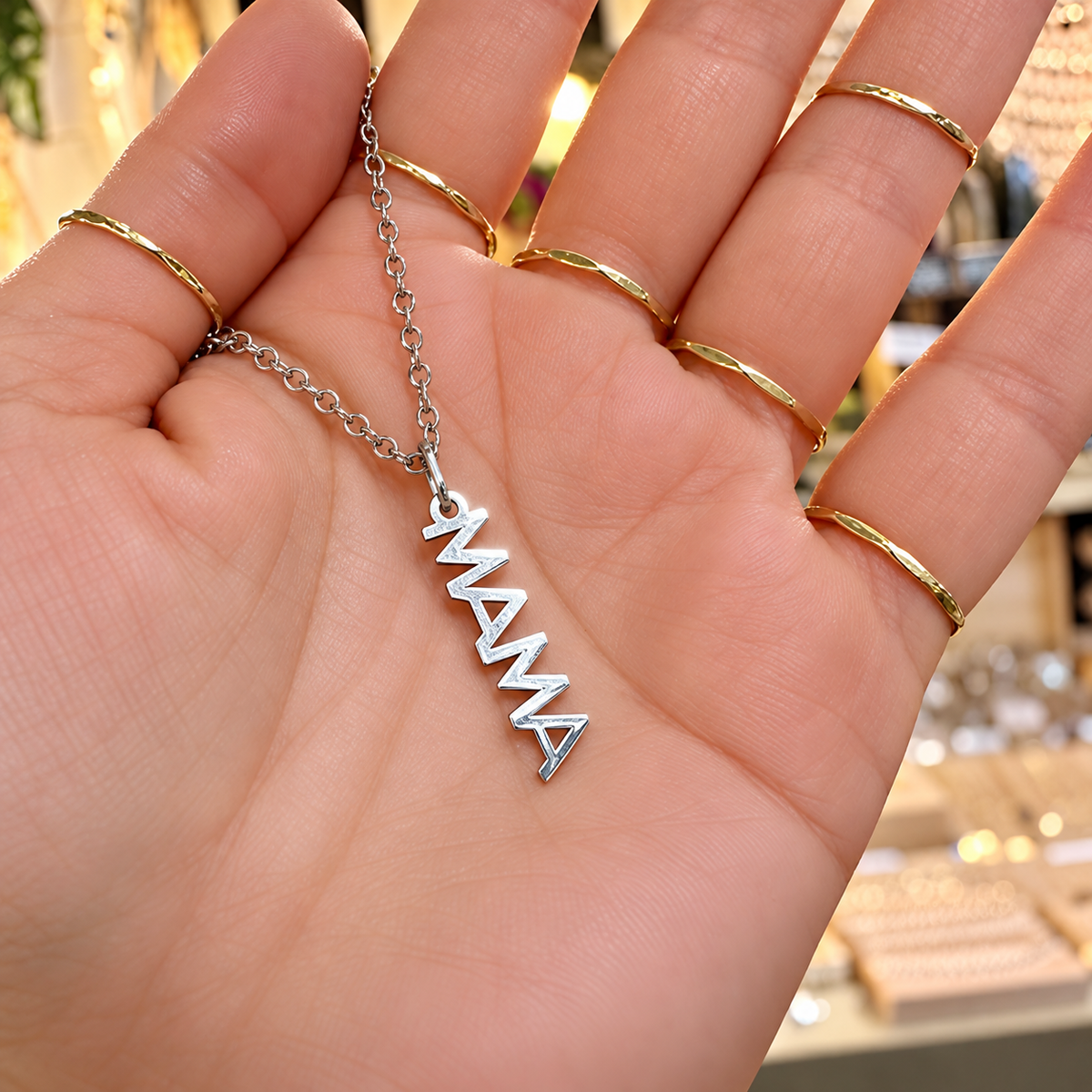 Silver MAMA word necklace held in the hand - Let's Jam, Camden Town