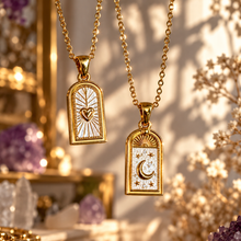 Load image into Gallery viewer, Gold arch pendants with a heart and a crescent moon, styled with flowers - Let's Jam, Camden Market, London