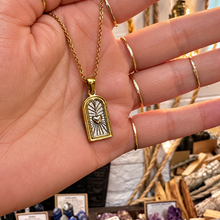 Load image into Gallery viewer, Gold arch pendant with a heart held in the hand - Let's Jam, Camden Market London
