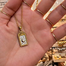 Load image into Gallery viewer, Gold arch pendant with a crescent moon held in the hand - Let's Jam, Camden Town London