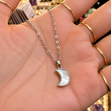 Load image into Gallery viewer, Silver mother of pearl crescent moon necklace held in the hand - Let's Jam, Camden Town