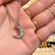 Load image into Gallery viewer, Silver crescent moon pendant set with zircon held in the hand - Let's Jam, Camden Town London