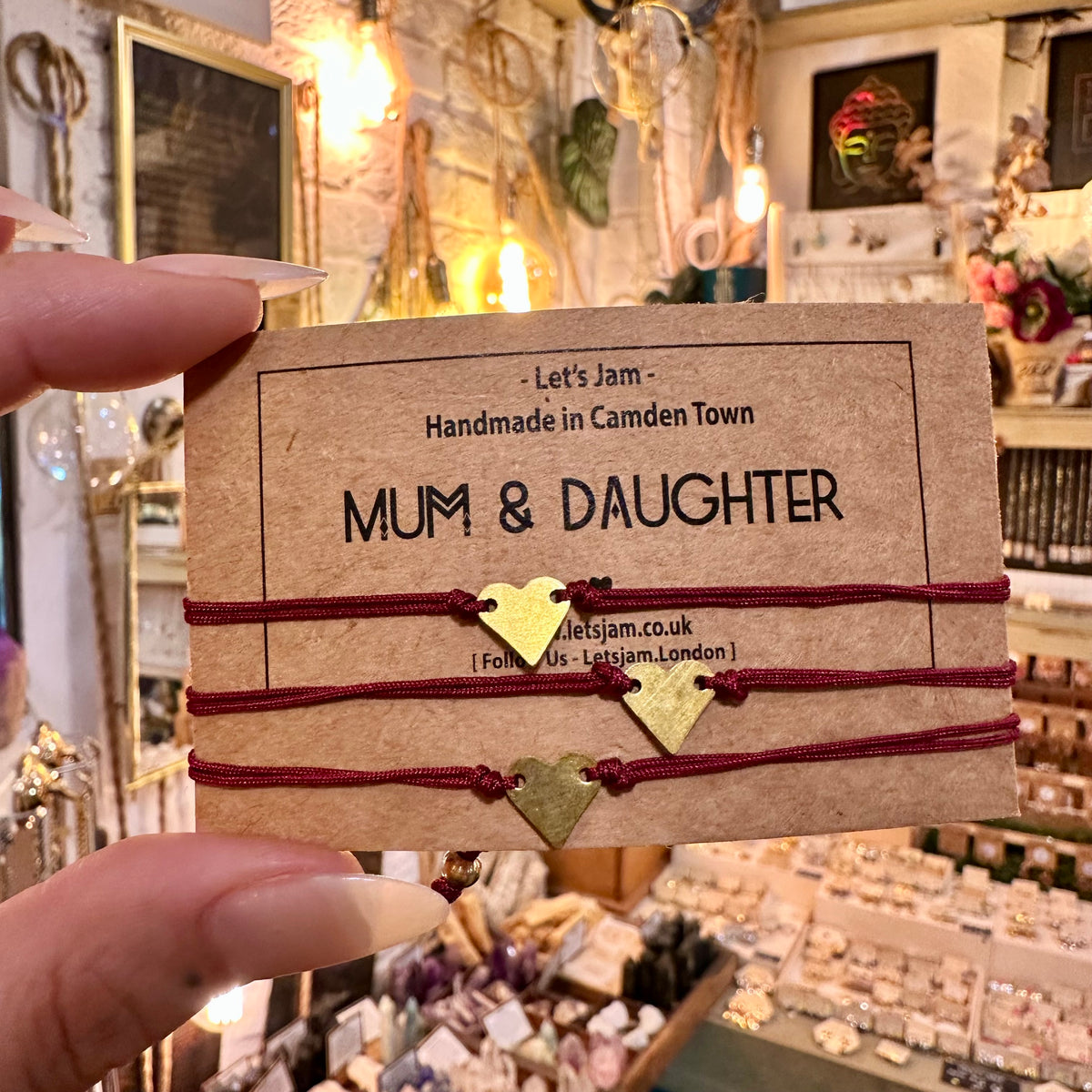Red cord bracelets with gold heart charms on a Mum & Daughter card - Let's Jam, Camden Market London