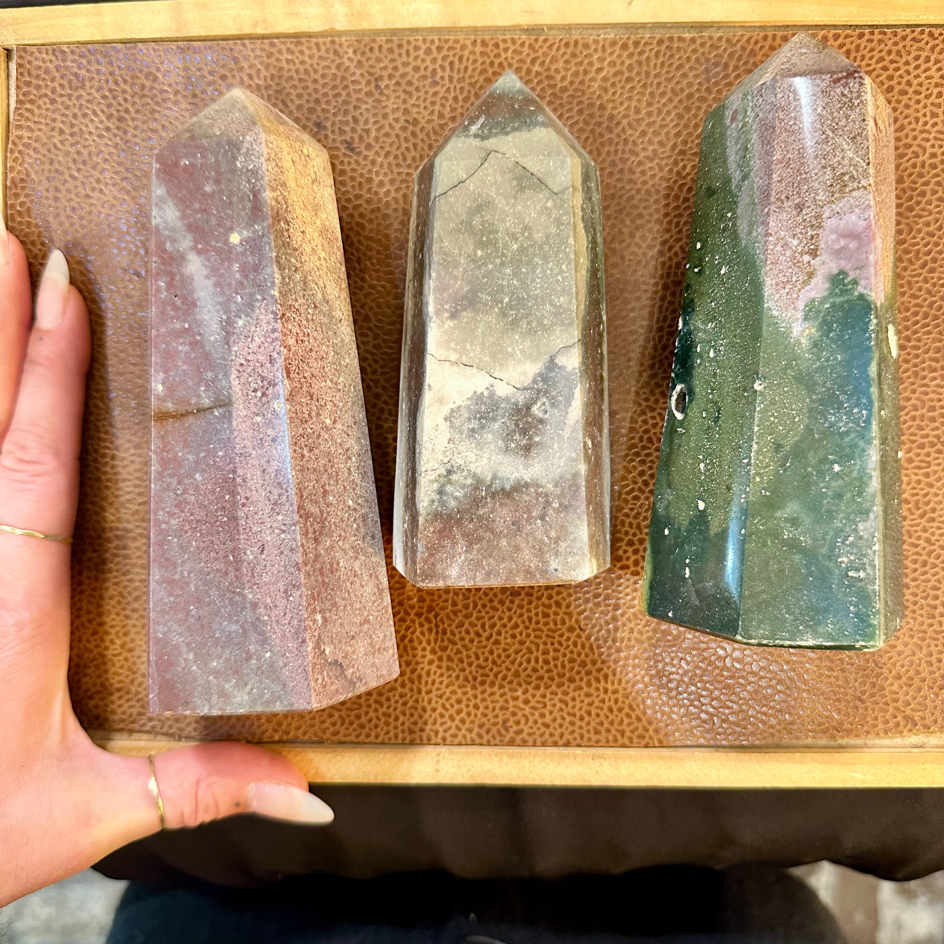 Ocean jasper trio laid out with a hand for scale - Let's Jam, Camden Market London