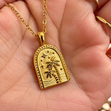 Load image into Gallery viewer, Gold arch pendant engraved with a palm tree held in the hand - Let's Jam, Camden Town