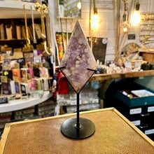 Load image into Gallery viewer, Pink amethyst on its stand photographed on display in the shop - Let's Jam, Camden Town