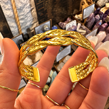 Load image into Gallery viewer, Twisted plait gold cuff held in the hand - Let's Jam jewellery, Camden Town London