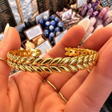 Load image into Gallery viewer, Gold plaited cuff bangle held in the hand - Let's Jam, Camden Town London