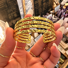 Load image into Gallery viewer, Gold cuff of four textured bands held in the hand - Let's Jam, Camden Market, London