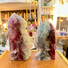 Load image into Gallery viewer, Pair of rainbow fluorite towers standing side by side in the shop - Let's Jam, Camden Town