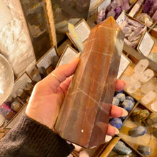 Load image into Gallery viewer, Red jasper crystal tower held in the hand to show its size - Let's Jam, Camden Market, London