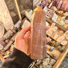 Load image into Gallery viewer, Red jasper tower with cream veining held up in the shop - Let's Jam, Camden Town