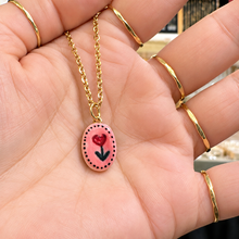 Load image into Gallery viewer, Oval pink ceramic pendant hand painted with a red rose in the hand - Let's Jam, Camden Market, London