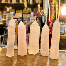 Load image into Gallery viewer, Row of pale pink rose quartz crystal points, each one slightly different - Let's Jam, Camden Market, London