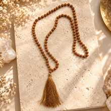Load image into Gallery viewer, Rudraksha seed mala with a brown tassel laid flat - Let's Jam jewellery, Camden Market, London