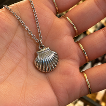 Load image into Gallery viewer, Silver scallop shell pendant held in the hand - Let's Jam jewellery, Camden Market London