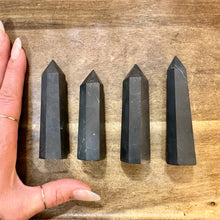 Load image into Gallery viewer, Four shungite towers next to a hand to show their size - Let's Jam, Camden Market London