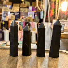 Load image into Gallery viewer, Four black shungite towers standing in a row in the shop - Let's Jam, Camden Town