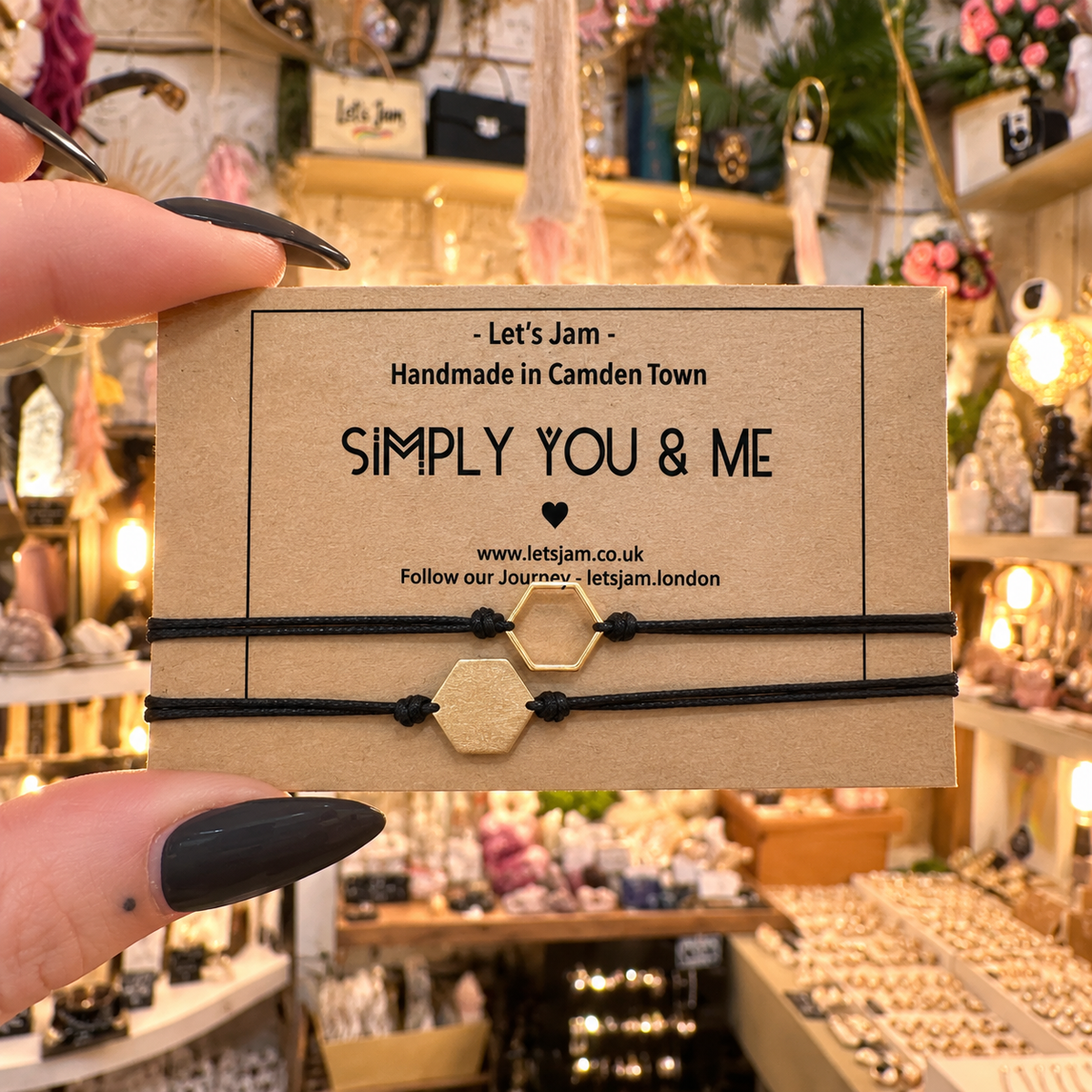 Two black cord bracelets with a gold hexagon charm on a Let's Jam "Simply You & Me" card - Let's Jam, Camden Market, London