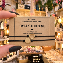 Load image into Gallery viewer, Two black cord bracelets with a gold hexagon charm on a Let's Jam "Simply You & Me" card - Let's Jam, Camden Market, London