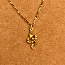 Load image into Gallery viewer, Gold snake pendant on a fine chain on a tan background - Let's Jam, Camden Market, London