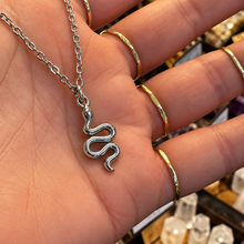 Load image into Gallery viewer, Silver serpent pendant held in the hand - Let's Jam jewellery, Camden Market