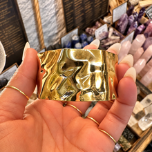 Load image into Gallery viewer, Wide molten texture gold cuff held in the hand - Let's Jam, Camden Town London
