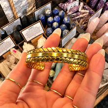 Load image into Gallery viewer, Thick plaited gold cuff bangle held in the hand - Let's Jam jewellery, Camden Market London