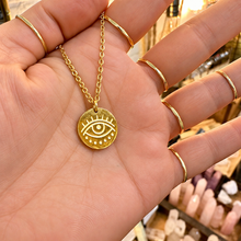 Load image into Gallery viewer, Gold third eye coin pendant held in the hand - Let's Jam, Camden Town London