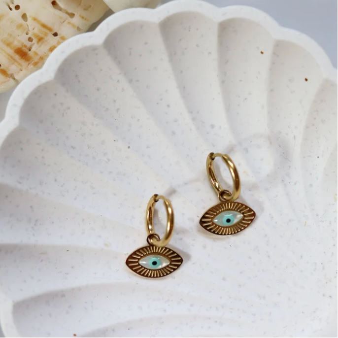 Pair of gold huggie hoops with eye charms in a white shell dish - Let's Jam, Camden Town