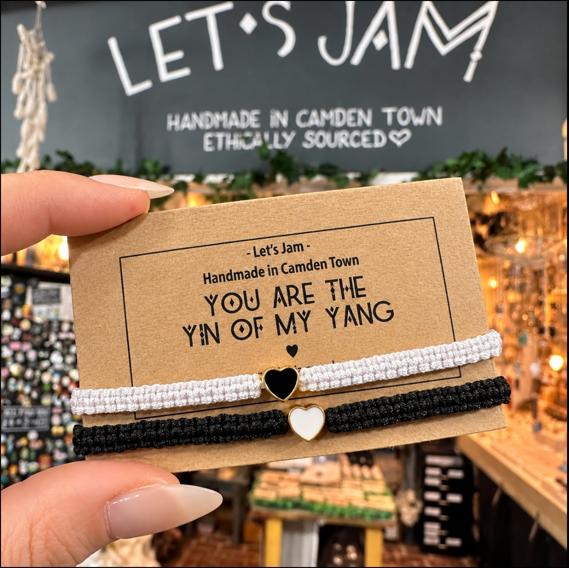 Two black cord bracelets with little gold heart charms on a Let's Jam "You Are The Yin Of My Yang" card - Let's Jam, Camden Market, London