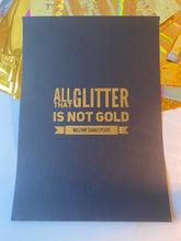 Load image into Gallery viewer, A black print with the William Shakespeare quote "All that glitters is not gold" in gold lettering, beside iridescent gift wrap - Let's Jam print collection