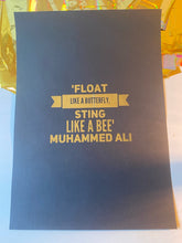 Load image into Gallery viewer, A black print with the Muhammad Ali quote "Float like a butterfly, sting like a bee" in gold lettering, beside iridescent gift wrap - Let's Jam print collection