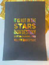 Load image into Gallery viewer, A black print with the William Shakespeare quote "It is not in the stars to hold our destiny but in ourselves" in rainbow holographic lettering, beside iridescent gift wrap - Let's Jam print collection