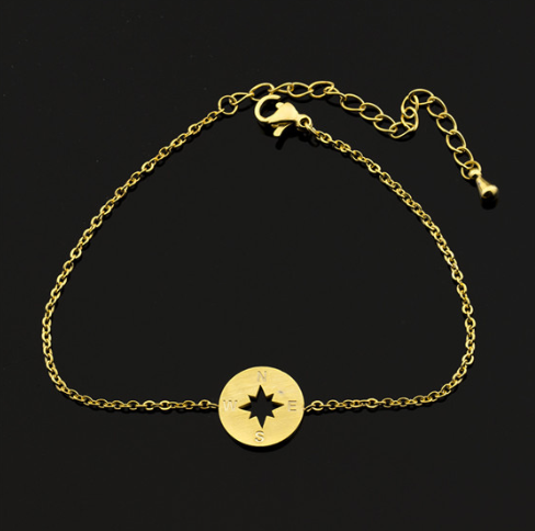 Compass charm bracelet fastened on a wrist, chain hanging softly - Let's Jam, Camden Market London