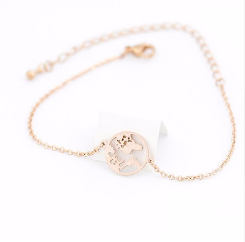 World map disc charm bracelet shown at an angle on a slim chain - Let's Jam, Camden Market London