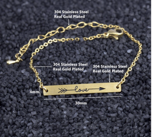 Close-up of the arrow engraving on a slim bar bracelet - Let's Jam, Camden Town London