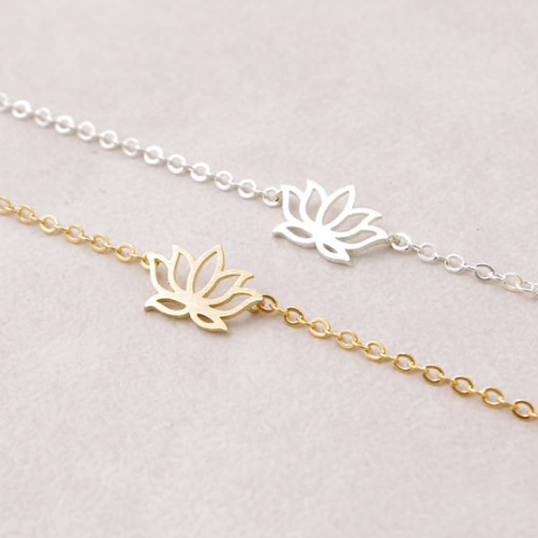 Gold and silver lotus flower charm bracelets laid side by side on delicate chains - Let's Jam jewellery collection