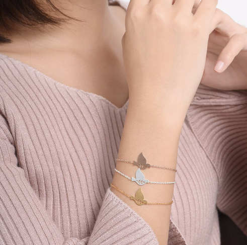 Gold, silver and rose gold dove bird charm bracelets stacked on wrist - Let's Jam jewellery collection