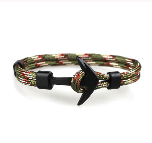 Black woven men's bracelet coiled beside its silver anchor hook - Let's Jam, Camden Town London
