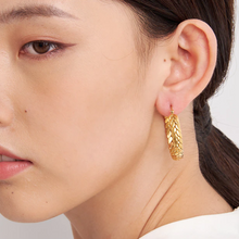 Load image into Gallery viewer, Bold gold hoop earrings worn with a plain top, studio lighting - Let's Jam, Camden Town