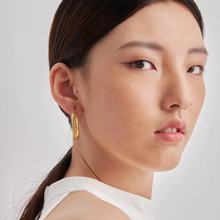 Load image into Gallery viewer, Model in profile wearing a thick gold hoop earring, sleek hair - Let's Jam, Camden Market