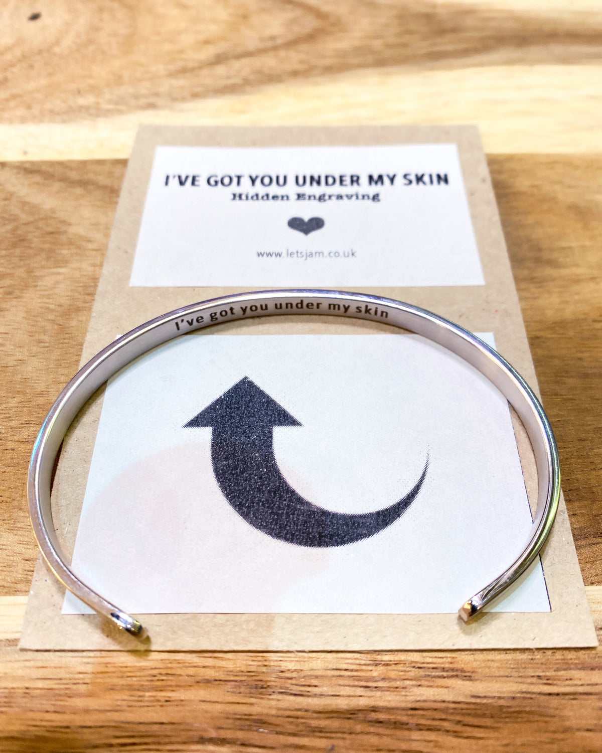Stainless steel cuff opened slightly to reveal the secret message - Let's Jam jewellery, Camden Market London