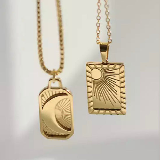 Moon necklace held up against the light to show the charm outline - Let's Jam, Camden Market